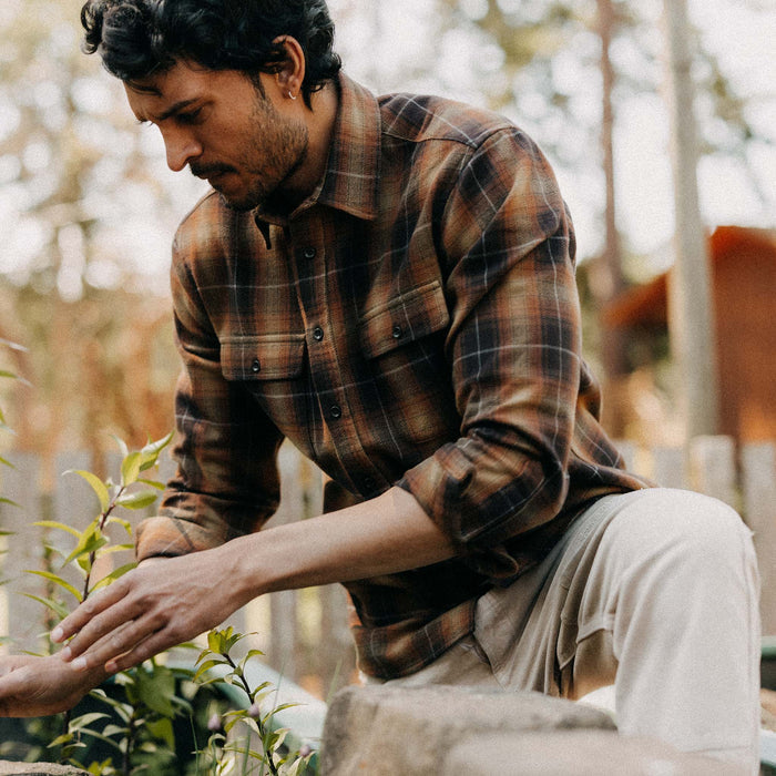 fit model kneeling wearing The Yosemite Shirt in Bonfire Plaid