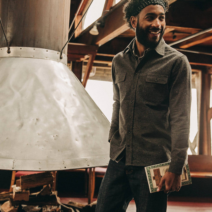 fit model wearing The Yosemite Shirt in Charcoal Donegal, holding book