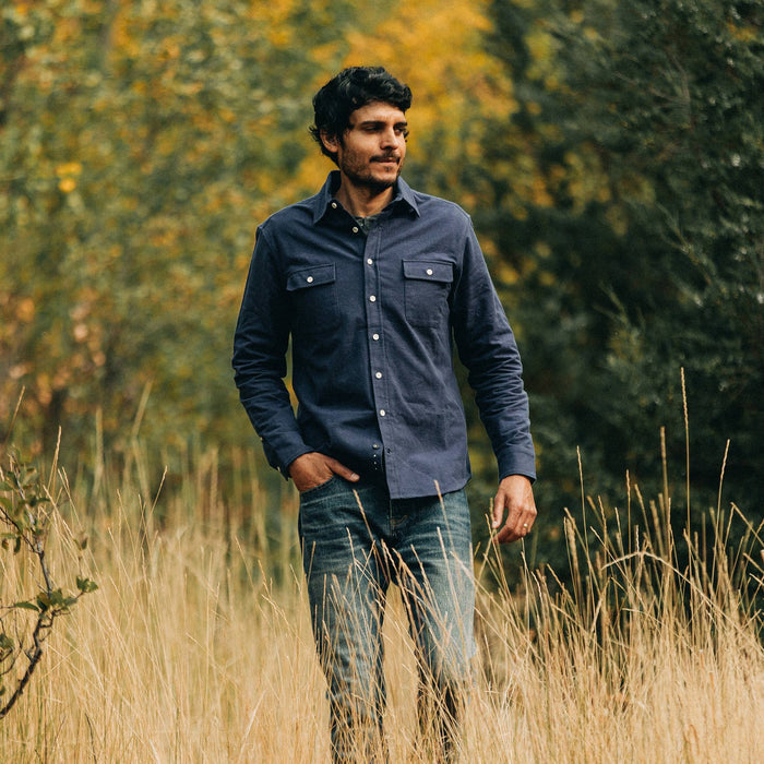 fit model wearing The Yosemite Shirt in Navy, walking in field