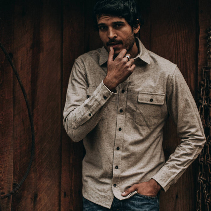 fit model wearing The Yosemite Shirt in Oat Donegal—standing near barn