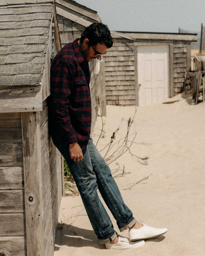 fit model leaning against a wall wearing The Yosemite Shirt in Port Plaid