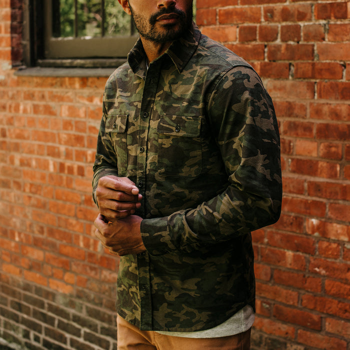 fit model adjusting his cuffs wearing The Yosemite Shirt in Trail Camo