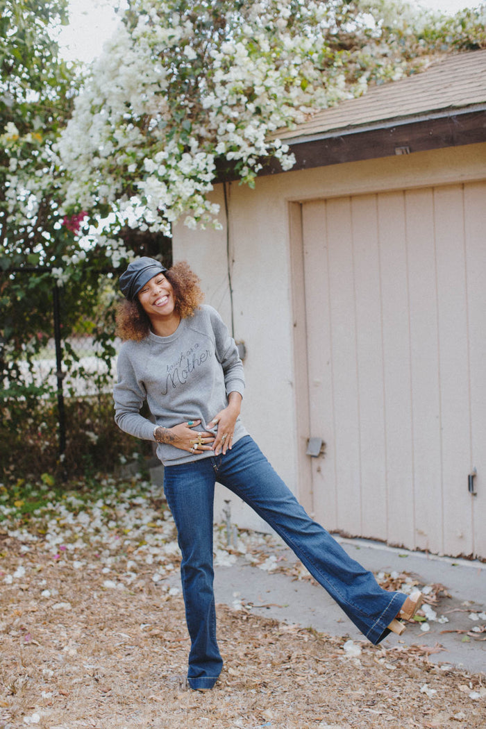 Woman standing under a blossom tree in Grey Tough as a Mother Sweatshirt in Unisex by The Bee and The Fox