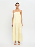 Woman wearing a light yellow dress on a white background