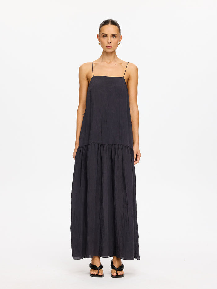 KIVARI Umi Maxi Dress in Charcoal – full-length front view of model wearing women's charcoal spaghetti strap tiered maxi dress