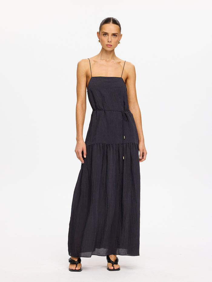 KIVARI Umi Maxi Dress in Charcoal – full-length front view of model wearing women's charcoal spaghetti strap tiered maxi dress with drawstring waist