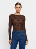 KIVARI Victoria Lace Top. Woman wearing a brown lace long-sleeve top and blue jeans on a white background